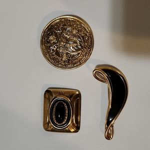 Black and gold brooches